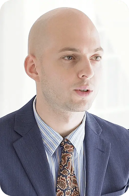 A.Pさんがスーツとストライプのシャツを着用したポートレート