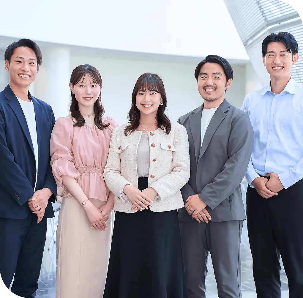 スーツ姿の男女が並んで笑顔で立つ様子